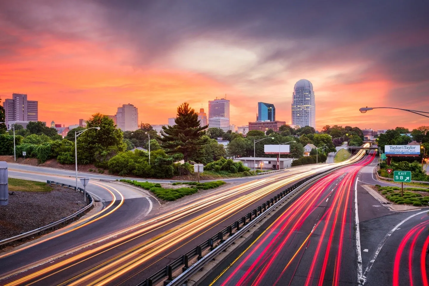 A city skyline with a highway going through it.